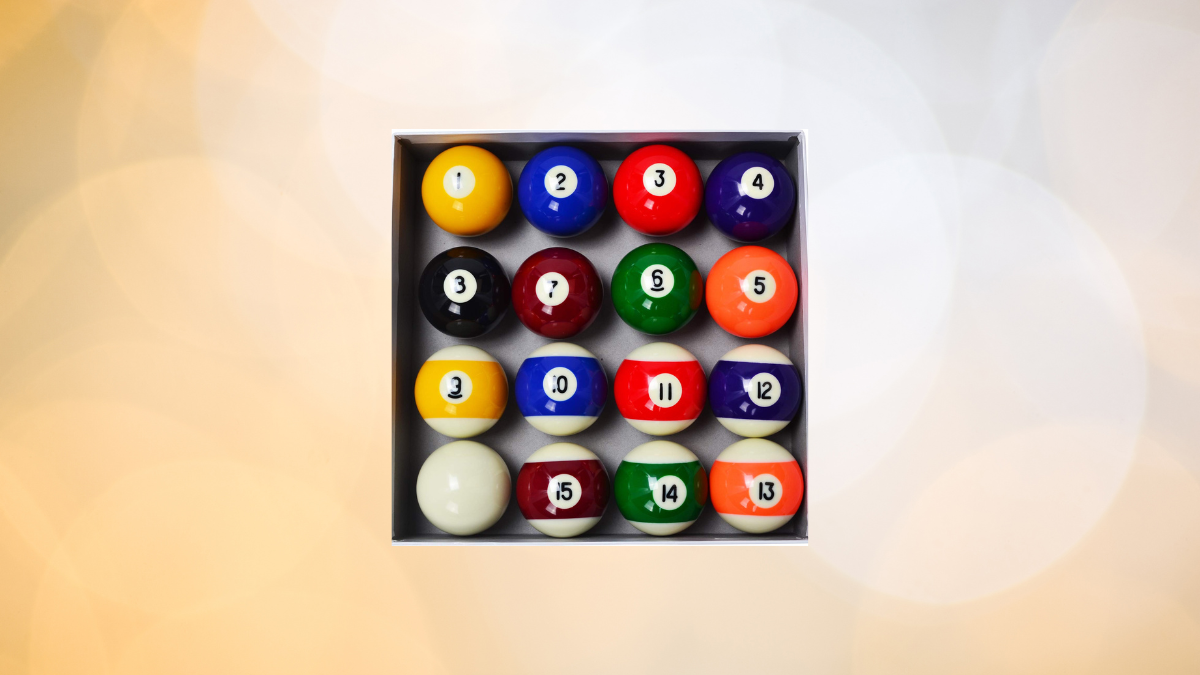 This image features a boxed set of billiard balls arranged in numerical order. The vibrant balls include both solids and stripes, with the classic white cue ball included.